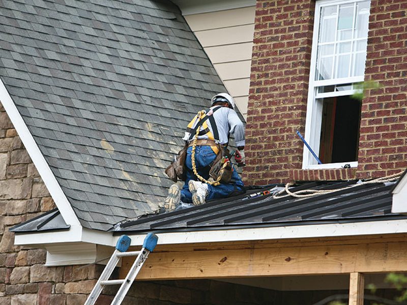 Repairs being made by man on a roof In Sevierville TN
